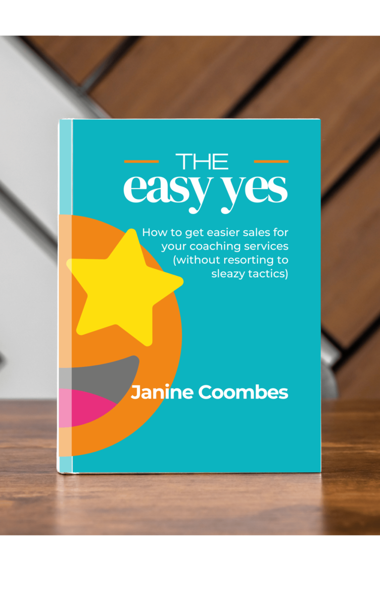 image is a mock up of a book standing on a wooden table. It's called The Easy Yes-How to get easier sales for your coaching services (without resorting to sleazy tactics) by Janine Coombes. The background is a teal blue with a big star eyed emoji- orange face, yellow stars for eyes