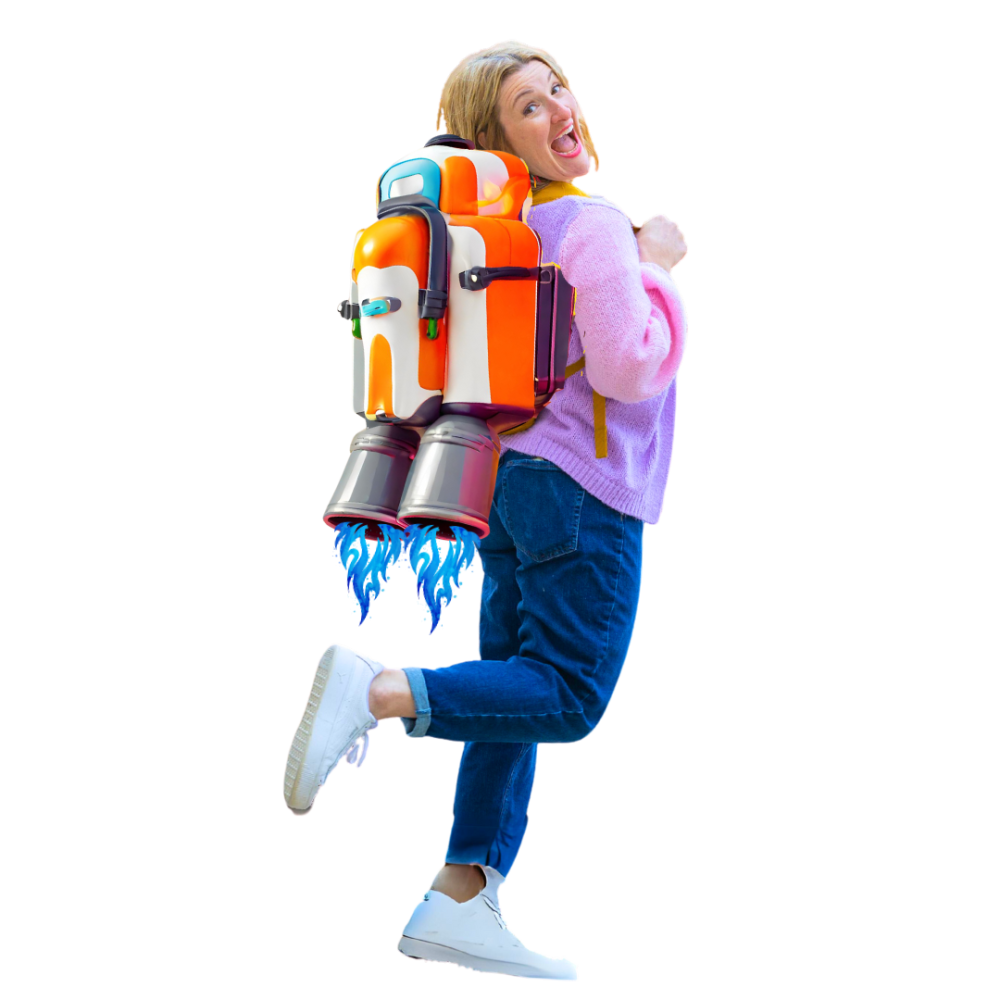 Janine Coombes stands with her back 3/4 to the camera. She looks over her shoulder smiling. She's a white middle aged woman with shoulder length mid blonde hair. She wears a pink and purple cardigan, dark blue jeans and white trainers. On her back is a bright orange and white jetpack with blue flames coming out of the metallic nozzles at the bottom.